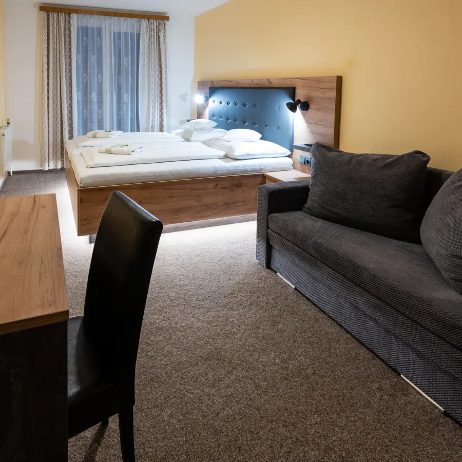 Spacious room with a double bed and a sofa bed