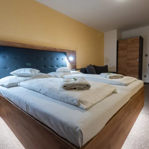 Room with a double bed and a sofa