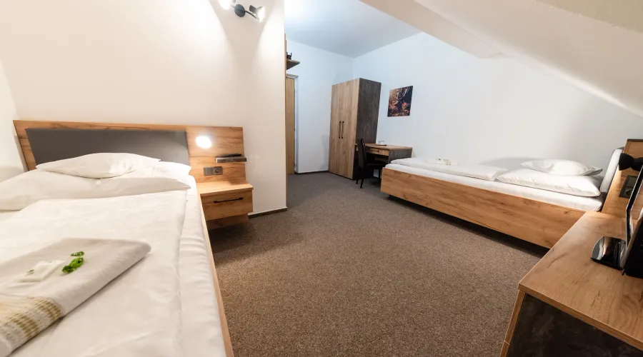 Attic room with a double bed and an extra bed